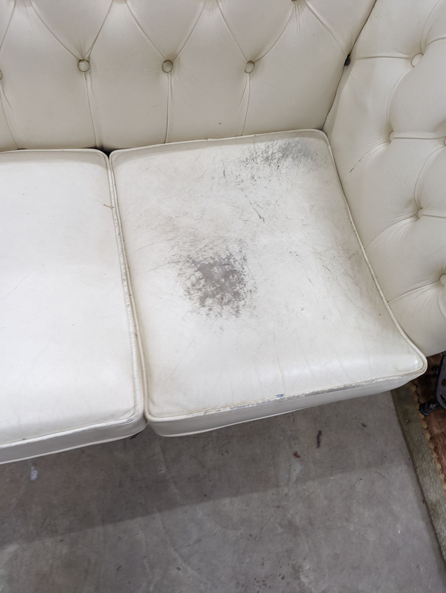 A Victorian style buttoned white leather Chesterfield settee, length 190cm, depth 86cm, height 72cm